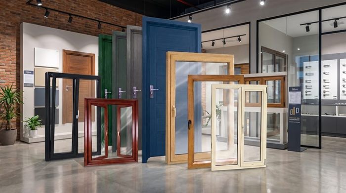 Showroom display of custom doors in multiple colors alongside window samples